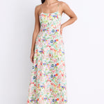 Model wearing a floral strappy maxi dress with a tie detail and shirred back.