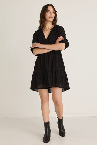 Model wears a black Mini Dress