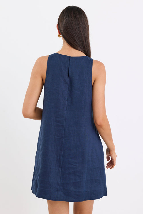 Woman wearing a blue sleeveless dress on a white background