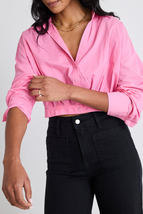 Model wears pink cropped shirt and black Jeans