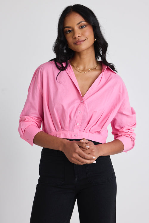 Model wears pink cropped shirt and black Jeans