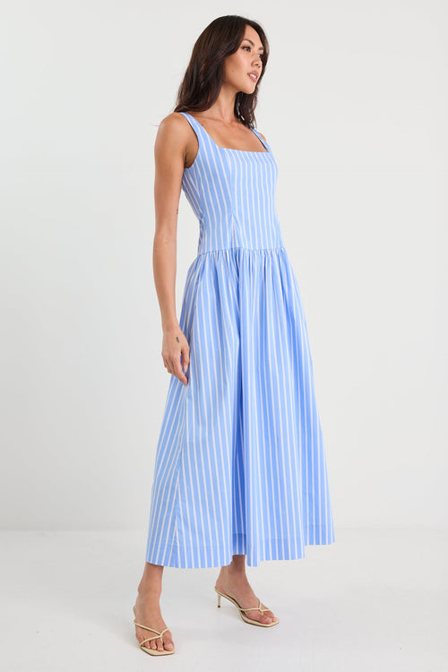 Woman wearing a blue and white striped dress on a white background