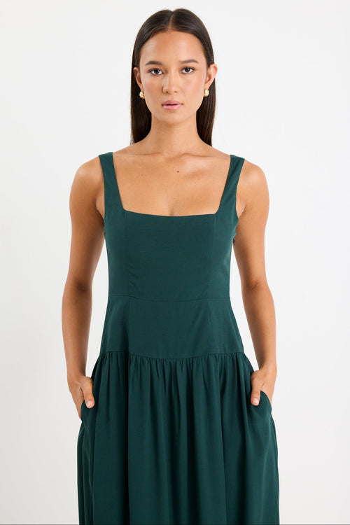 Woman wearing a green dress against a white background