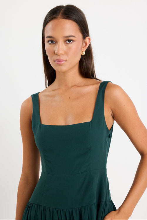 Woman wearing a green dress against a white background