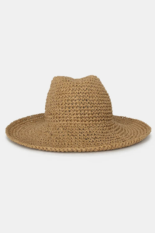 A natural straw fedora hat with a wide brim, photographed from the side against a clean, light gray background.