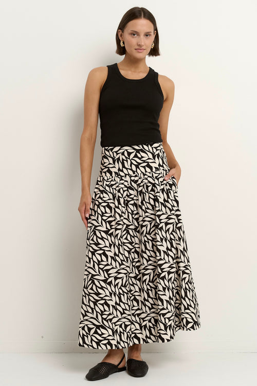 our model wears a black and white floral print maxi skirt with a black tank