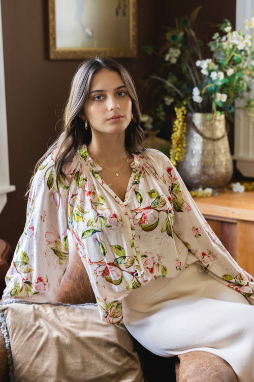 model wears a floral blouse