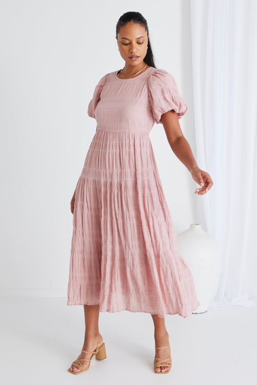 model wears a pink midi dress