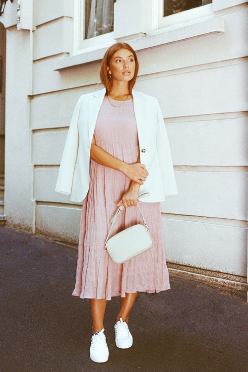 model wears a pink midi dress