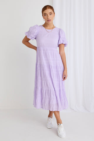 Model wears purple midi dress