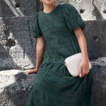 Model wears a forest green maxi dress