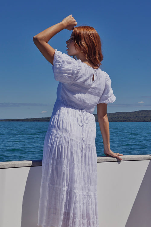 model wears a white maxi dress