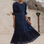 model wears a dark blue maxi dress