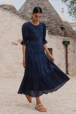 model wears a dark blue maxi dress