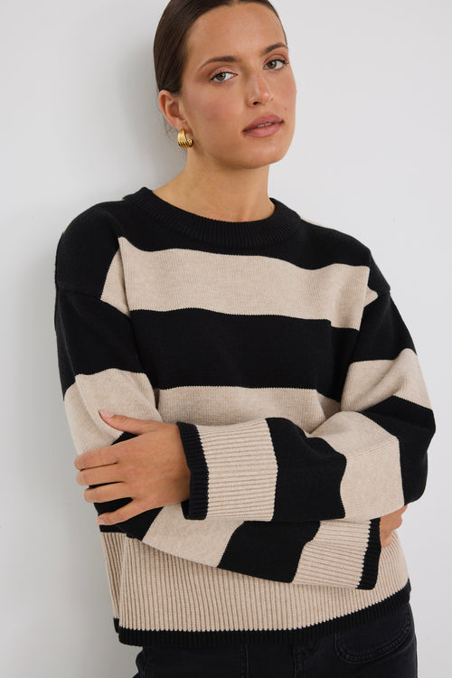 Model wears a black and beige stripe jumper