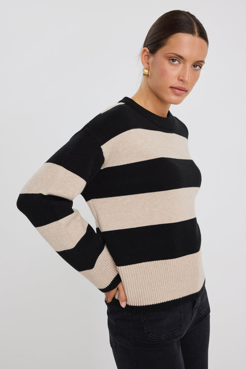 Model wears a black and beige stripe jumper