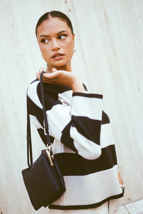 model wears a beige and black stripe knit