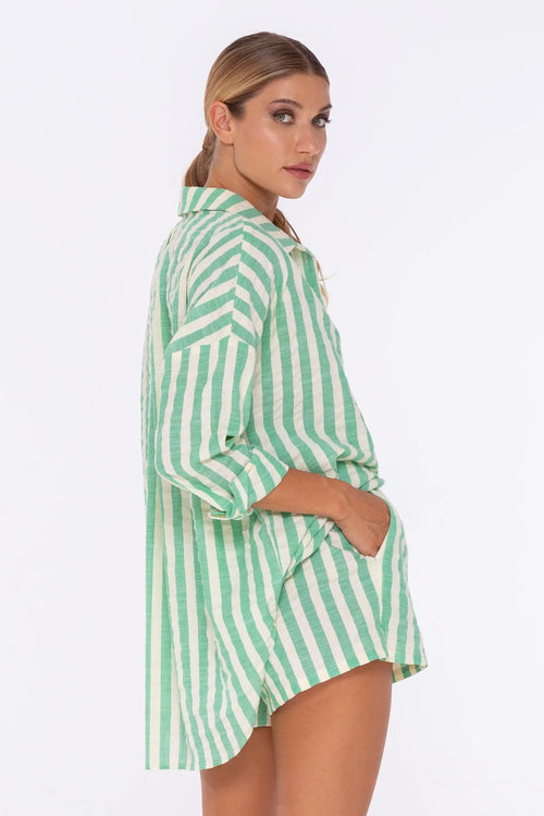 model wears a green strip shirt 