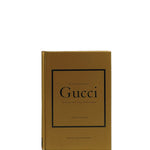 Gucci book with gold cover and black text on a white background