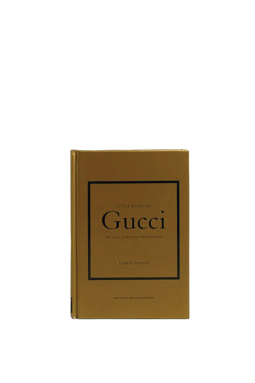 Gucci book with gold cover and black text on a white background