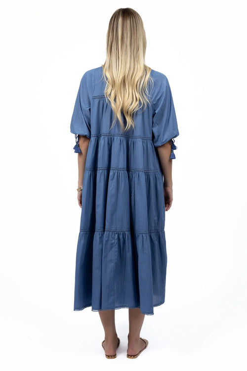 Woman wears a navy blue maxi dress