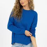 model wears a blue knit jumper