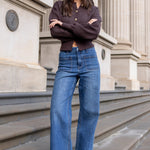 Woman standing on steps in front of a classical building