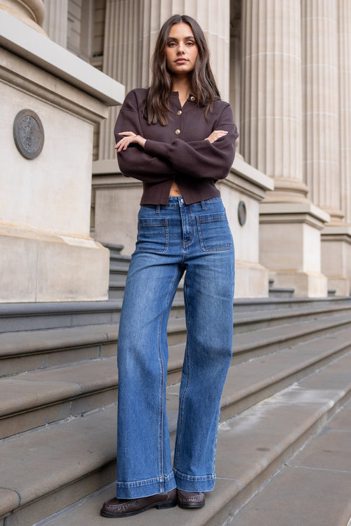 Woman standing on steps in front of a classical building