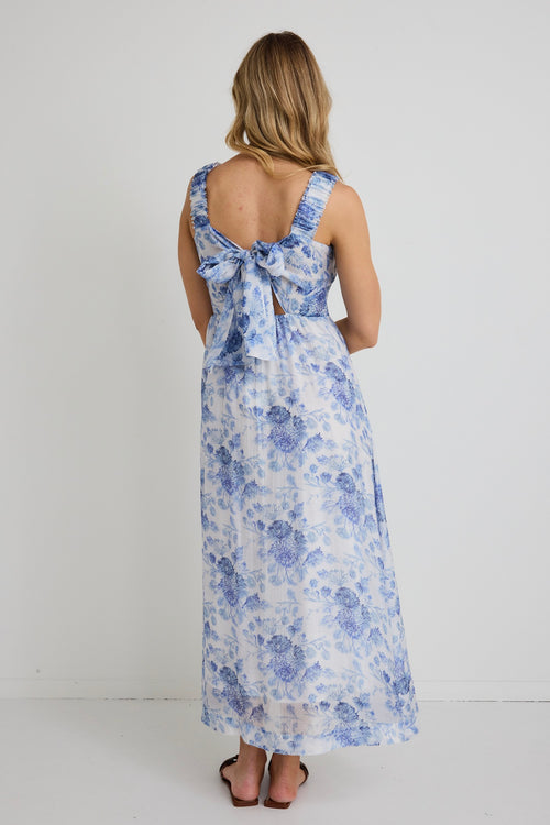 model wears blue floral maxi dress and brown sandals