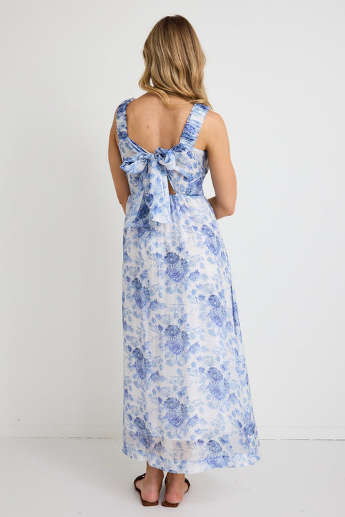 model wears a blue floral maxi dress