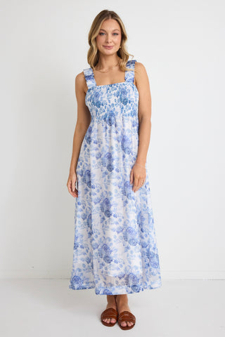 model wears a blue floral maxi dress