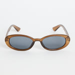 Slim oval sunglasses with a translucent espresso-brown frame and dark tinted lenses, photographed on a white background