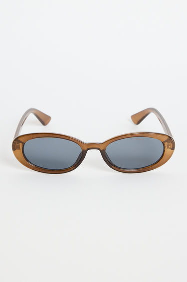 Slim oval sunglasses with a translucent espresso-brown frame and dark tinted lenses, photographed on a white background