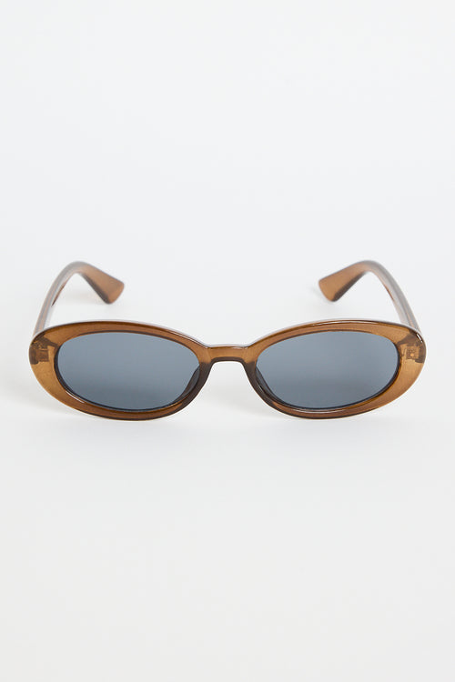Slim oval sunglasses with a translucent espresso-brown frame and dark tinted lenses, photographed on a white background