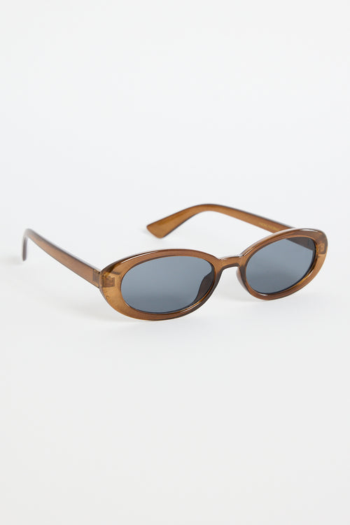 Slim oval sunglasses with a translucent espresso-brown frame and dark tinted lenses, photographed on a white background