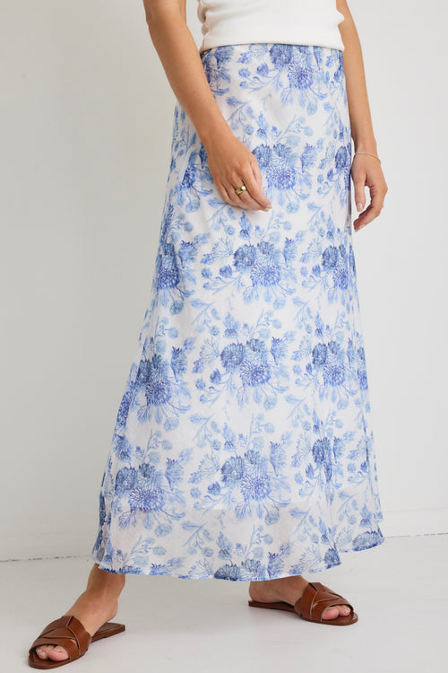 model wears a blue floral maxi skirt