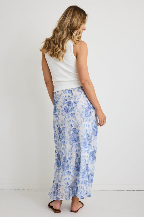 model wears a blue floral maxi skirt