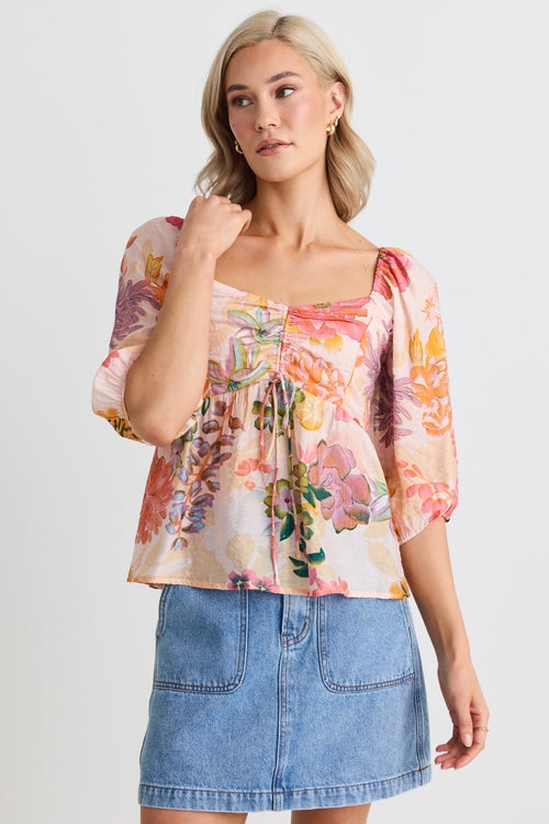 model wears a pink floral top