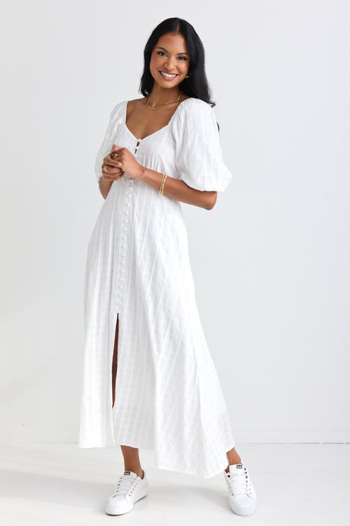 model wears a white midi dress