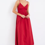 Model wearing a plum strappy midi dress, featuring a relaxed fit and linen-cotton blend fabric with a smooth, polished finish.