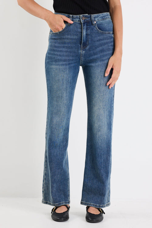 Person wearing blue jeans on a white background