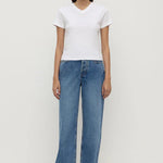 Person wearing a white t-shirt and blue jeans on a white background