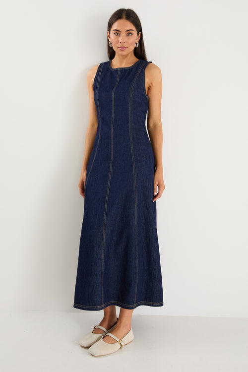 Woman wearing a navy blue dress against a white background