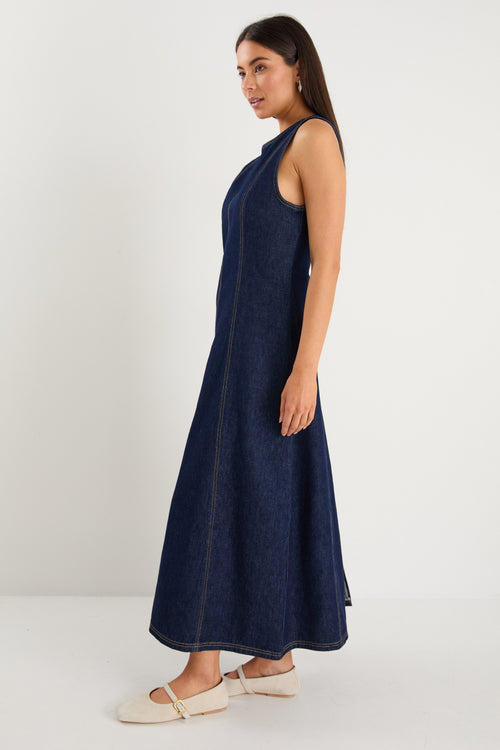 Woman wearing a navy blue sleeveless dress on a white background