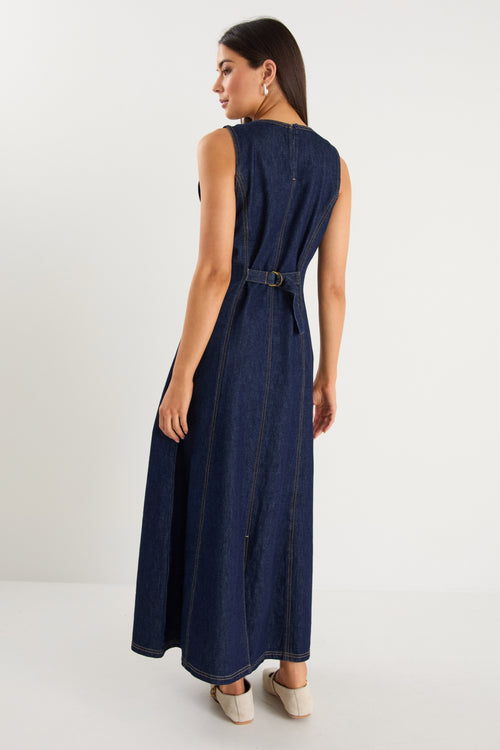 Woman wearing a navy blue dress with a belt on a white background