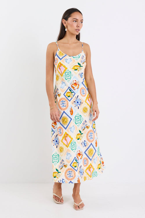 Model wearing a Bias Slip Dress in a vibrant, tropical print.