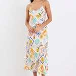 Model wearing a Bias Slip Dress in a vibrant, tropical print.