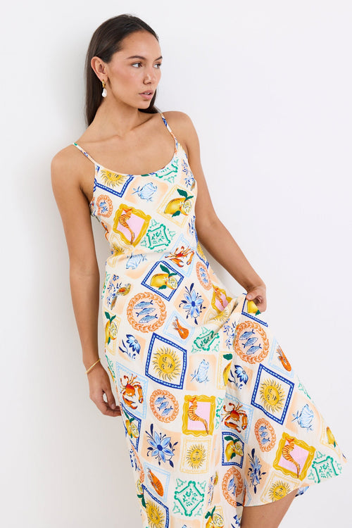 Model wearing a Bias Slip Dress in a vibrant, tropical print.