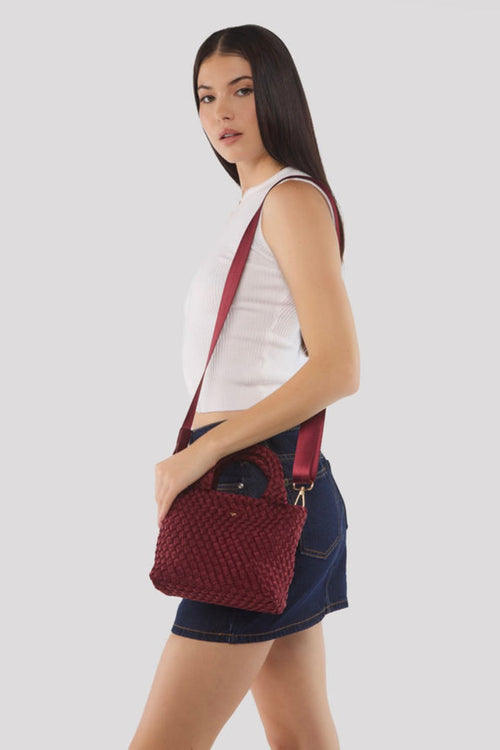 Cherry red woven mini tote bag with top handles and a soft textured finish