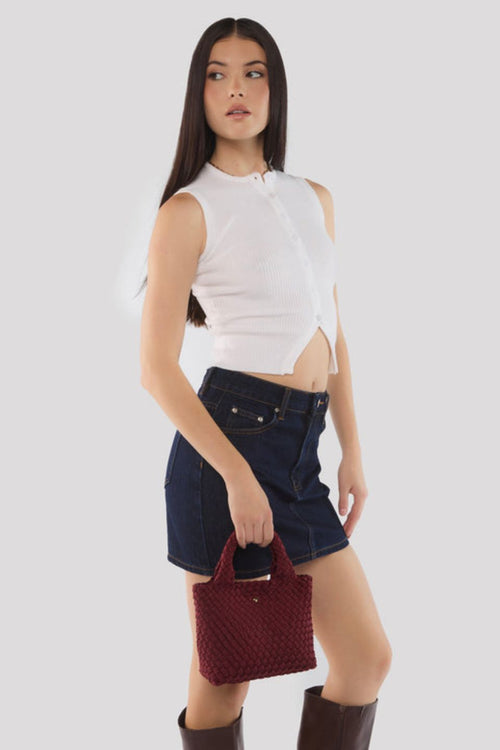 Cherry red woven mini tote bag with top handles and a soft textured finish